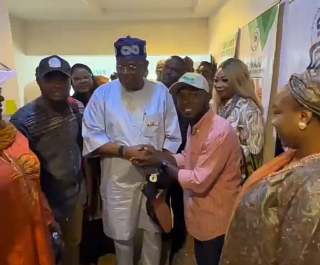 James Abiodun Faleke receives specially branded Tinubu emblem footwear from ANCY National Director Gabriel Joshua Ojochebe during a courtesy visit in Abuja.