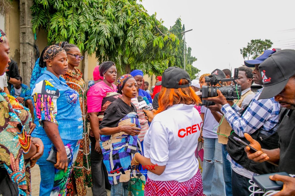 Beneficiaries receiving meals during APCYN-WA's weekly humanitarian outreach in Lagos.